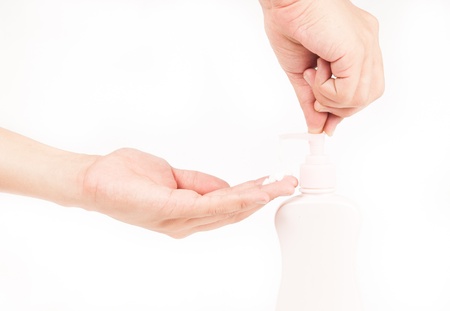 Closeup of beautiful female hands applying hand cream isolatedの写真素材