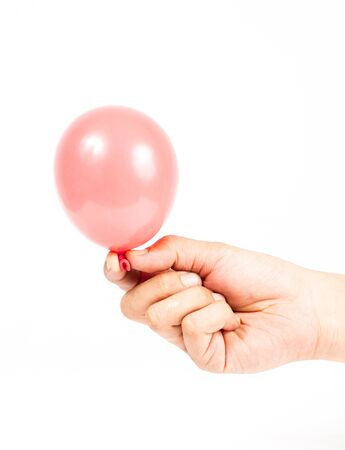 Hand holding colorful helium balloons isolated on white backgroundの写真素材