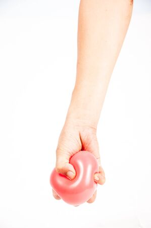 Hand holding colorful helium balloons isolated on white backgroundの写真素材