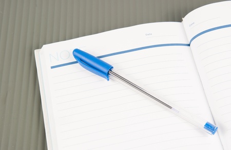 Open note book with lined pages free date space and ballpoint penの写真素材
