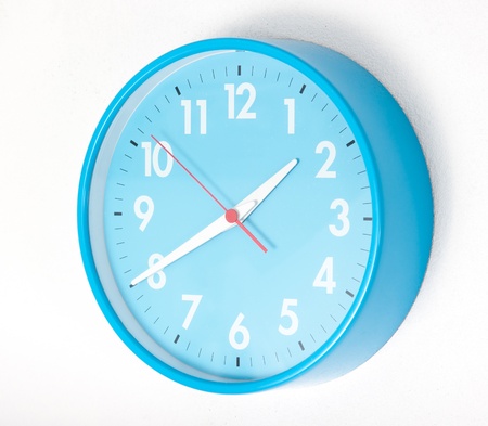 A blue wall clocks on white groundの写真素材