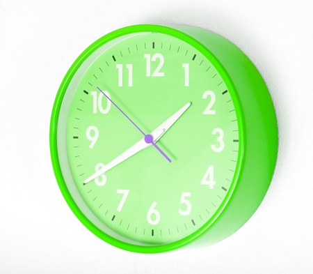 A green wall clocks on white groundの写真素材