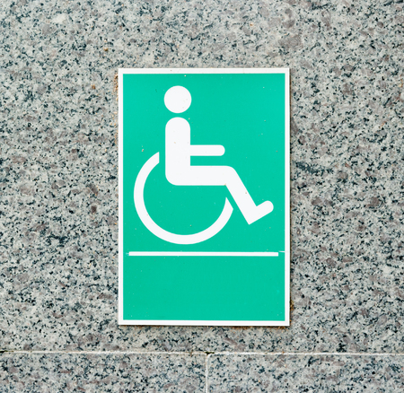 disabled person sign on brick wallの写真素材