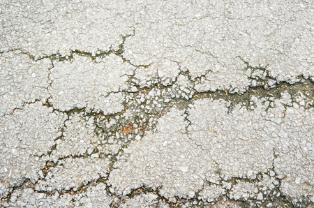 old asphalt with large cracksの写真素材