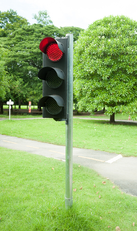 Traffic sign in a country road with the red light onの写真素材