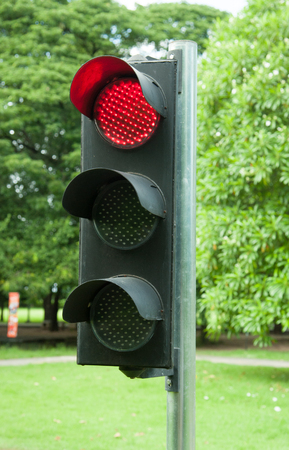 Traffic sign in a country road with the red light onの写真素材