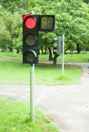 Traffic sign in a country road with the red light onの写真素材