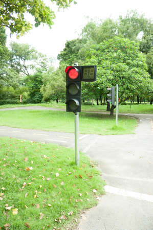 Traffic sign in a country road with the red light onの写真素材