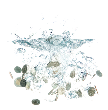 coins falling into the clear waterの写真素材