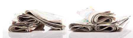 Various newspapers over white backgroundの写真素材