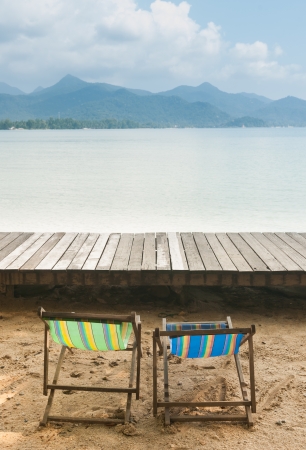 Seaside resort with a chair on the beach. Looking forward to the sea and sky.の写真素材