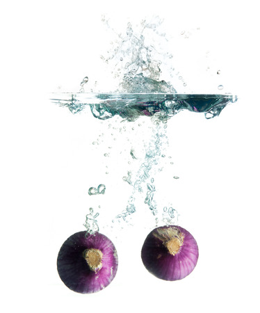 Red sliced onion isolated on white backgroundの写真素材