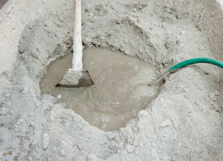 spade and wet cement image for construction processの写真素材