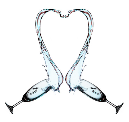 Heart splash from two glasses of water isolated on white backgroundの写真素材