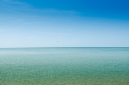Summer landscape with sea and horizon over waterの写真素材