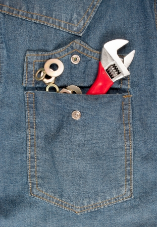 closeup of an adjustable wrench in a jean pocketの写真素材