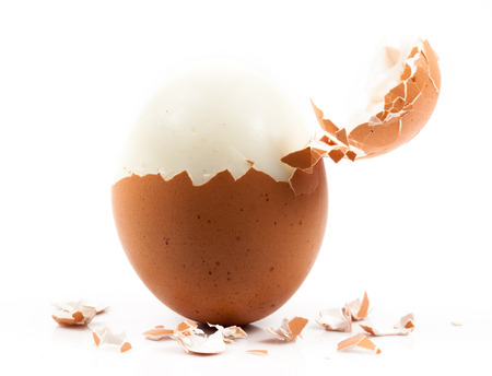 peeled boiled egg on white background