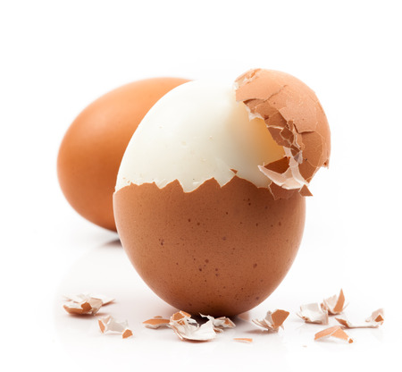 peeled boiled egg on white backgroundの写真素材