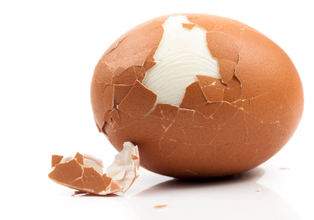 peeled boiled egg on white background
