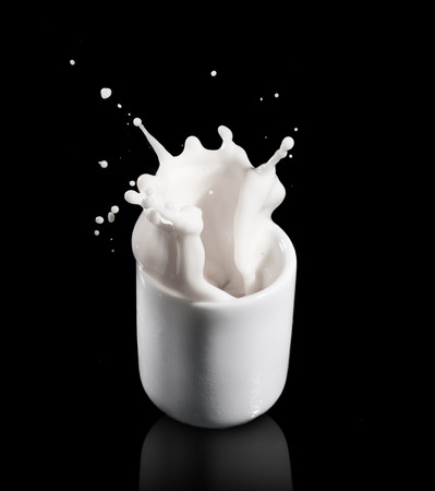milk splashing from the glassの写真素材