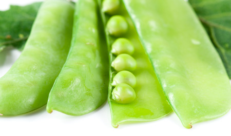 Fresh pea pods with flower isolated on whiteの写真素材
