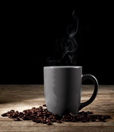 coffee cup, coffee beans and cinnamon sticks on dark backgroundの写真素材