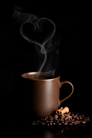 aromatic cup of coffee with smoke and beansの写真素材