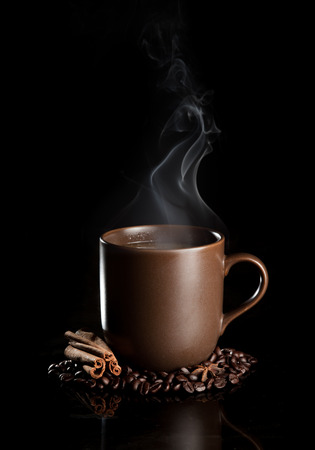 aromatic cup of coffee with smoke and beansの写真素材