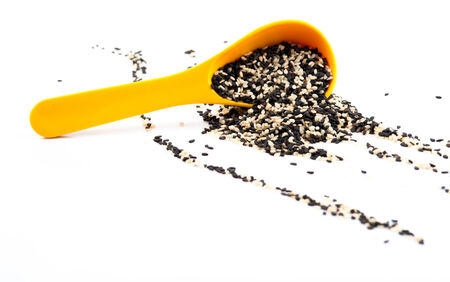black and white sesame seeds isolated on white background