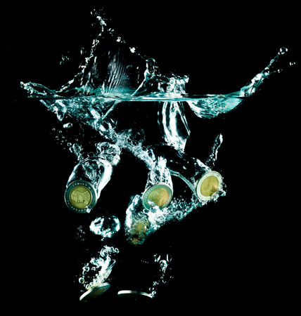 coins falling down to waterの写真素材