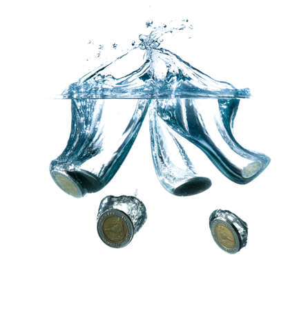 money in water with bubbles on white backgroundの写真素材