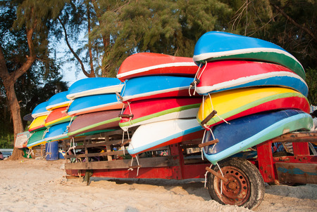 Colorful plastic boats on a rack ashoreの写真素材