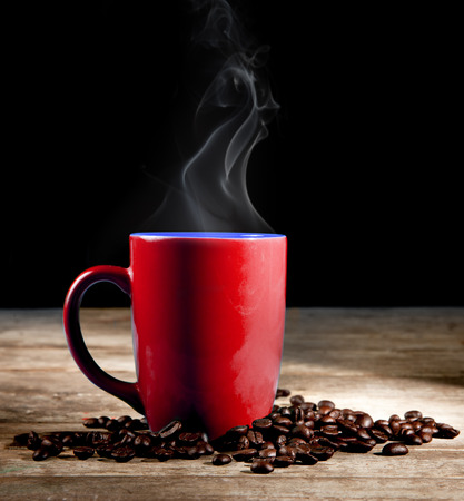 Steaming coffee cup on dark backgroundの写真素材