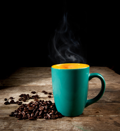 Green Coffee cup with coffee beansの写真素材
