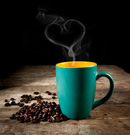 Green Coffee cup with coffee beansの写真素材