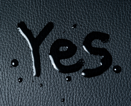 The word "YES" on black skinの写真素材