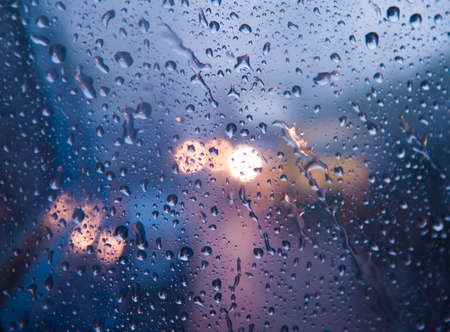 Water drops on glass with bokehの写真素材