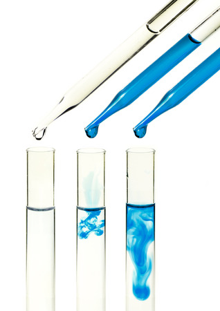 liquid dripping from pipette into test tube isolatedの写真素材