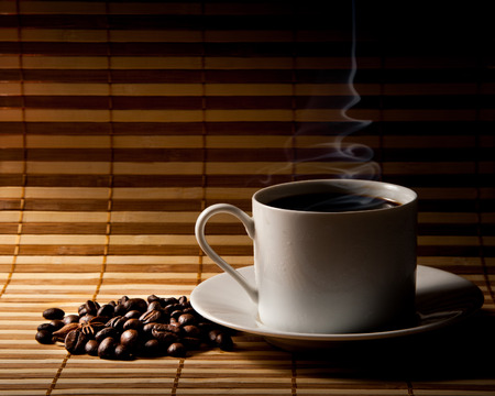 Coffee cup and saucer on a woodenの写真素材