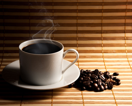 Coffee cup and saucer on a woodenの写真素材