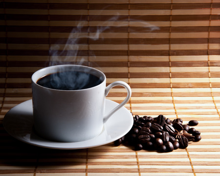 Coffee cup and saucer on a woodenの写真素材