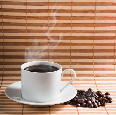 Coffee cup and saucer on a woodenの写真素材