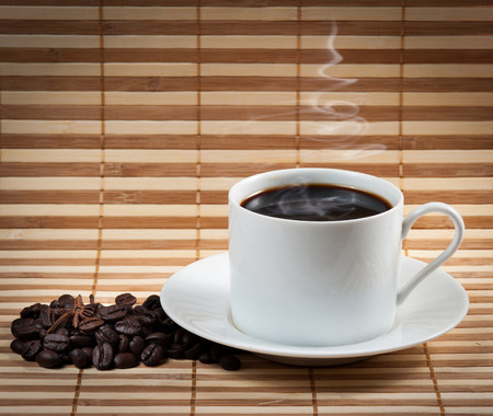 Coffee cup and saucer on a woodenの写真素材