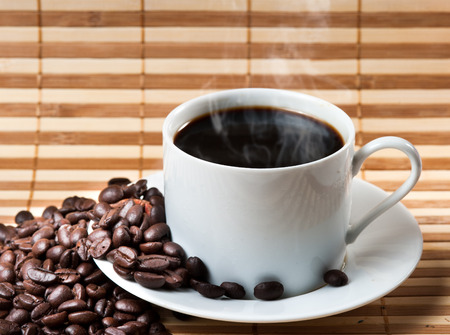Coffee cup and saucer on a woodenの写真素材