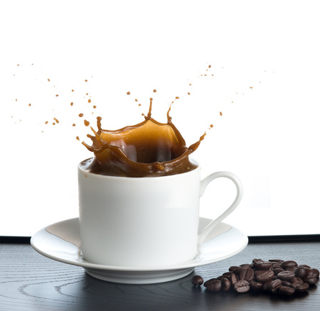 splash coffee isolated on white backgroundの写真素材