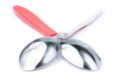 dessert spoon with its shadow on whiteの写真素材
