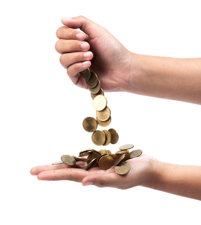 hand pour down coins into hands of another person.の写真素材