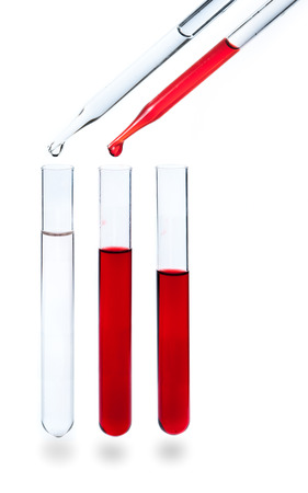 liquid dripping from pipette into test tube isolatedの写真素材