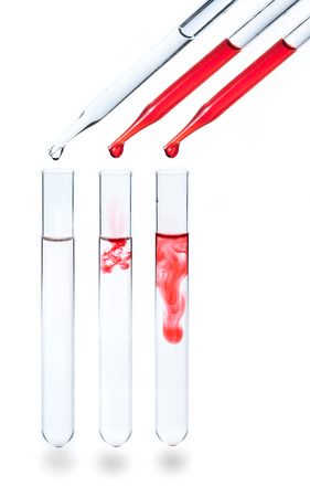 liquid dripping from pipette into test tube isolatedの写真素材