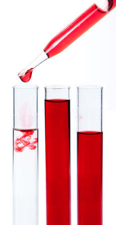 liquid dripping from pipette into test tube isolatedの写真素材